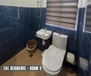 a bathroom with a toilet and a sink at E&E Residence in Locsin