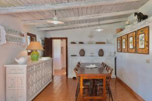 a kitchen with a table and chairs in a room at Porto Ercole Prestige Villa in Cala Galera