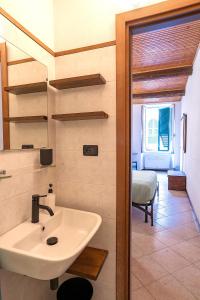 a bathroom with a sink and a room with a bed at Macaia Village Life Room with AC #2 in Vernazza