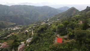 an aerial view of a mountain village in a valley at Kamalú Glamping in Medellín