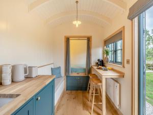 a kitchen with blue cabinets and a counter top at Shepherd's Retreat in Ongar