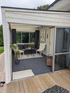 a screened in patio with a couch and a table at Tiny house accommodation in Frillesås! in Frillesås