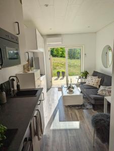 a kitchen and living room in a tiny house at Tiny house accommodation in Frillesås! in Frillesås