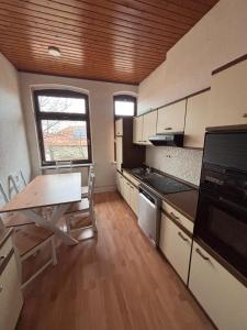 a small kitchen with a table and a table sidx sidx sidx at Emmerstedt - Alte Schule in Helmstedt +3 photos