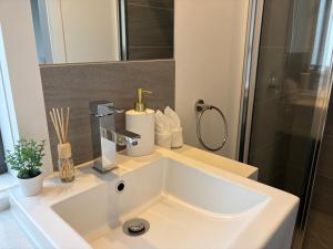 a white sink in a bathroom with a shower at Monash Ensuite room with shared kitchen & laundry in Oakleigh East