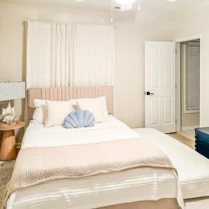 a bedroom with a large white bed with a blue pillow at Spacious Private 2BR-2BA I Pool I Garage I Central in Rehoboth Beach