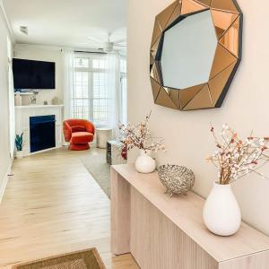 a living room with a mirror on the wall at Spacious Private 2BR-2BA I Pool I Garage I Central in Rehoboth Beach