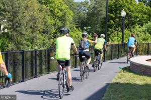 a group of people riding bikes down a sidewalk at Beach perfect getaway 2 bedroom apartment in Rehoboth Beach +21 photos