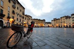 a bike with a basket parked on a street at La Dimora di Luca in Bientina