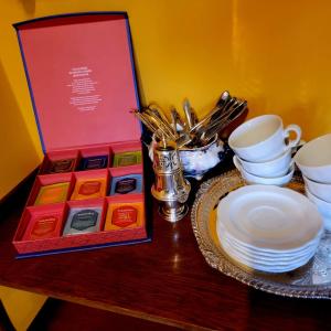 a table with a box and plates and cups on it at La Dimora di Luca in Bientina +43 photos