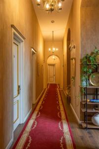 a hallway with a red rug on the floor at Rustaveli Hotel in Tbilisi City