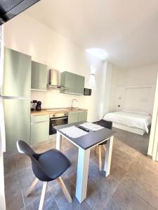 a kitchen with a table and chairs in a room at Cavour 16 Biella Studio Centro in Biella