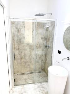 a shower with a glass door in a bathroom at Cavour 16 Biella Studio Centro in Biella +11 photos