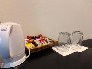 a table with two glasses and a basket of snacks at E - Central Room Five in Skopje