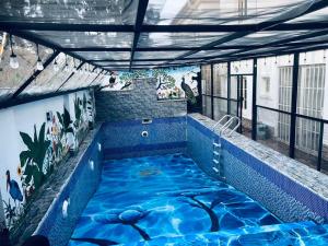 a swimming pool in the middle of a building at Deluxe Indulgence Hotel & Suites in Abuja