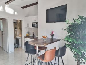 a kitchen and dining room with a wooden table and chairs at AURA Apartments Novalja in Novalja