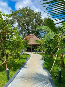 a path leading to a pavilion in a garden at Deluxe Indulgence Hotel & Suites in Abuja