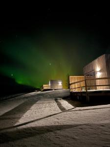 an image of the aurora borealis in the sky at Tommutún cottages in Borgarnes