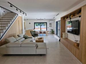 a living room with a white couch and a table at Villa Atma in Murine