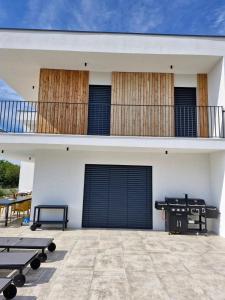 a white house with black doors and a patio at Villa Atma in Murine