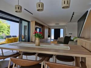 a dining room and living room with a table and chairs at Villa Atma in Murine