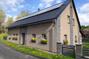 a house with solar panels on the side of it at Chalupy Severní in Lobendava
