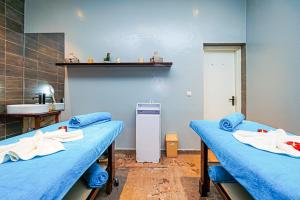 two beds in a hospital room with a sink at TUI BLUE Tamala in Kotu +37 photos