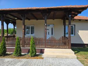 a house with a wooden fence and a porch at Konak Kragujevac in Kragujevac