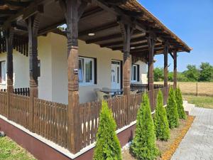 a porch with a wooden fence and some trees at Konak Kragujevac in Kragujevac