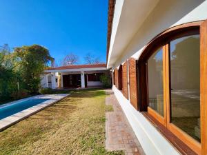 an external view of a house with a swimming pool at Estancia Bogotá in Ciudad Lujan de Cuyo