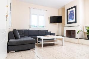a living room with a couch and a table at Dimeli 1 in Plaka Litochorou