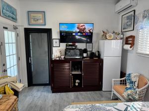 a living room with a refrigerator and a tv at Sea Shells in Nassau