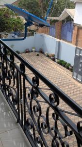 a black wrought iron fence with a brick patio at AvocadoAirbnb in Arusha +1 photo