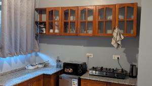 a kitchen with a stove and a counter top at AvocadoAirbnb in Arusha