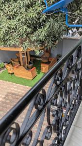 a black wrought iron railing with a garden in the background at AvocadoAirbnb in Arusha