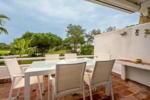 a white table and chairs on a patio at Quinta do Lago Duplex - Beach & Golf Algarve in Loulé