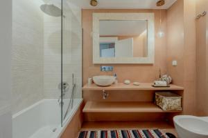 a bathroom with a sink and a glass shower at Quinta do Lago Duplex - Beach & Golf Algarve in Loulé +19 photos
