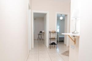 a living room with white walls and a tile floor at Dimeli in Litochoro +21 photos