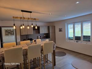 a kitchen and dining room with a table and chairs at Appartement de Charme in Bévilard +8 photos
