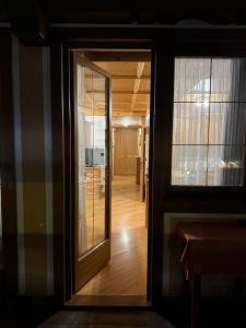 a door leading into a room with a hallway at Campiglio Trilocale Dolomiti in Madonna di Campiglio