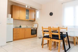 a kitchen with a table and chairs and a refrigerator at Dimeli in Litochoro