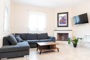 a living room with a couch and a coffee table at Dimeli in Litochoro