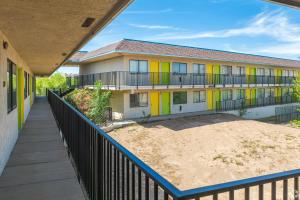 an apartment building with colorful windows and a walkway at Gazelle Stay by Hotel O Socorro in Socorro