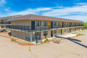 an apartment building with a parking lot at Gazelle Stay by Hotel O Socorro in Socorro +20 photos