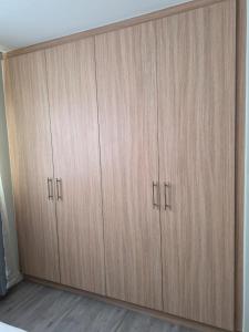 a pair of wooden cabinets in a room at Blouberg Guest suite, 3 km to the beach, Wi-Fi inc in Parklands +12 photos