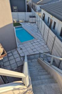 a stairway leading to a swimming pool in a house at Blouberg Guest suite, 3 km to the beach, Wi-Fi inc in Parklands