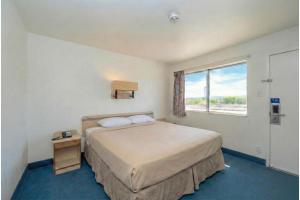 a hotel room with a bed and a window at Gazelle Stay by Hotel O Socorro in Socorro