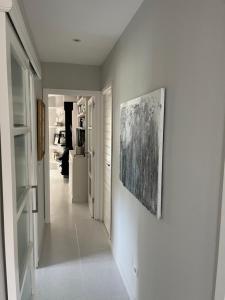 a hallway with a painting hanging on a wall at Minerva Beach in Port d'Alcudia