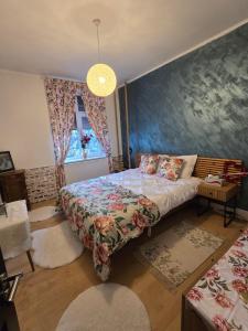 a bedroom with a bed and a blue wall at Mery in Craiova