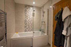a bathroom with a bath tub and a shower at The Briers Country House in Newcastle +113 photos
